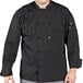 A man wearing a black Uncommon Chef long sleeve chef coat with mesh back.