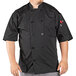 A man wearing a black Uncommon Chef Delray Pro Vent short sleeve chef coat with a mesh back.