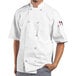 A man wearing a white Uncommon Chef Montego Pro Vent chef coat.