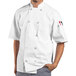 A man wearing a white Uncommon Chef Montego Pro Vent short sleeve chef coat with mesh back.