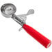 A red metal ice cream scoop with a thumb press.