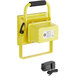 A yellow rectangular Lind Equipment rechargeable LED floodlight with a black handle.