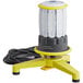A yellow and white Lind Equipment Beacon360 LED area light with a black cord attached to a floor stand.