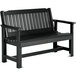 A black outdoor garden bench with a wooden back and armrests.