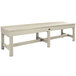 A white backless bench with a cross leg.