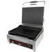 A Cecilware panini grill with grooved grill surfaces and a lid on a table.