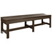 A brown backless bench with a weathered wood top and black legs.