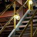 Yellow Lind Equipment LED string lights on a railing.