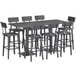 A Lancaster Table & Seating solid wood bar table with bar stools and chairs.