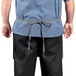 A man wearing a Uncommon Chef triple denim waist apron with a black belt.