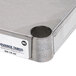 An Advance Tabco stainless steel shelf on a table.