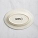 An ivory stoneware oval platter with embossed oval and wide rim.