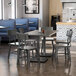 A Lancaster Table & Seating live edge dining table and chairs in a restaurant dining area.