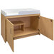 A Tot Mate maple laminate infant changing table with a cabinet.