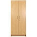 A Tot Mate maple wooden tall cabinet with two doors and handles.