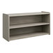 A Tot Mate Shadow Elm laminate toddler storage shelf with three shelves.