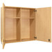 A Tot Mate maple wooden wall cabinet with open doors.