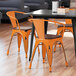 Lancaster Table & Seating Alloy Series Distressed Orange Metal Indoor Industrial Cafe Arm Chair with Vertical Slat Back and Walnut Wood Seat Main Thumbnail 1