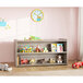 A Tot Mate Shadow Elm laminate toddler double sided storage shelf with toys on it.