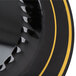 A close up of a black plastic plate with gold bands.