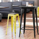 Lancaster Table & Seating Alloy Series Distressed Yellow Stackable Metal Indoor Industrial Barstool with Black Wood Seat Main Thumbnail 1