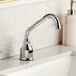 A Waterloo deck mount hands-free sensor faucet with a surgical bend gooseneck spout over a counter.