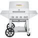 A Crown Verity stainless steel natural gas grill on wheels with side shelves and knobs.