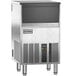An Ice-O-Matic undercounter ice machine with a stainless steel and black exterior.