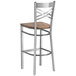 A Lancaster Table & Seating cross back bar stool with a wood seat.