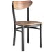 A Lancaster Table & Seating Boomerang Series chair with a wooden seat and back and black frame.