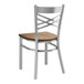 A Lancaster Table & Seating metal chair with a wood seat and back.