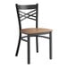 A Lancaster Table & Seating black and wood cross back chair.