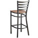 A Lancaster Table & Seating distressed copper finish ladder back bar stool with a vintage wood seat.