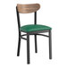 A Lancaster Table & Seating Boomerang Series black chair with green vinyl seat.
