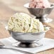 A scoop of ice cream in a Vollrath stainless steel sherbet dish.