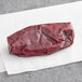 A piece of Kinikin Rocky Mountain elk stew meat on a white paper wrapper.