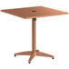 A brown square metal table with a black umbrella in the center.