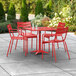 A red table and chairs on an outdoor patio.