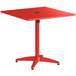 A red square Lancaster Table & Seating outdoor dining table with a metal base.