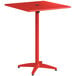 A red square Lancaster Table & Seating bar height table with a metal pole.