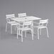 A white Lancaster Table & Seating outdoor dining table with chairs.