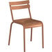 A brown metal chair with a brown plastic seat and metal legs.