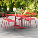 A red Lancaster Table & Seating outdoor dining set on a patio.