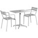 A Lancaster Table & Seating outdoor table and two chairs with a white background.