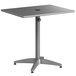 A matte gray Lancaster Table & Seating aluminum table with a metal base.