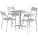 A Lancaster Table & Seating silver powder-coated aluminum table with 4 chairs.