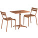 A Lancaster Table & Seating brown aluminum table with umbrella hole and two chairs.
