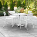 A white Lancaster Table & Seating table and chairs on a patio.