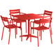 A red Lancaster Table and Seating outdoor table and 4 chairs set up on an outdoor patio.