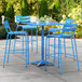 A blue table and chairs on a patio.